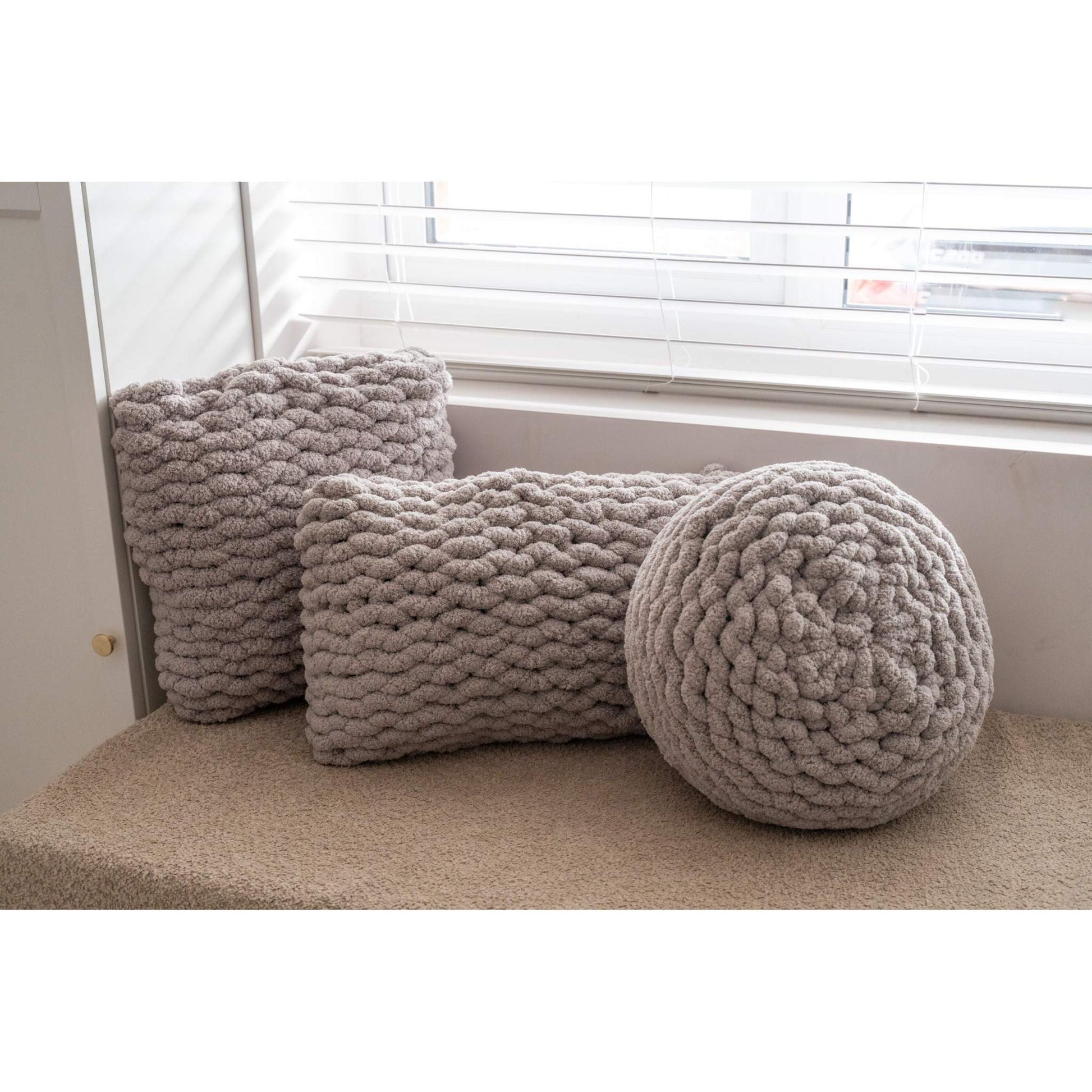 trio of hand knit cushions in grey taupe