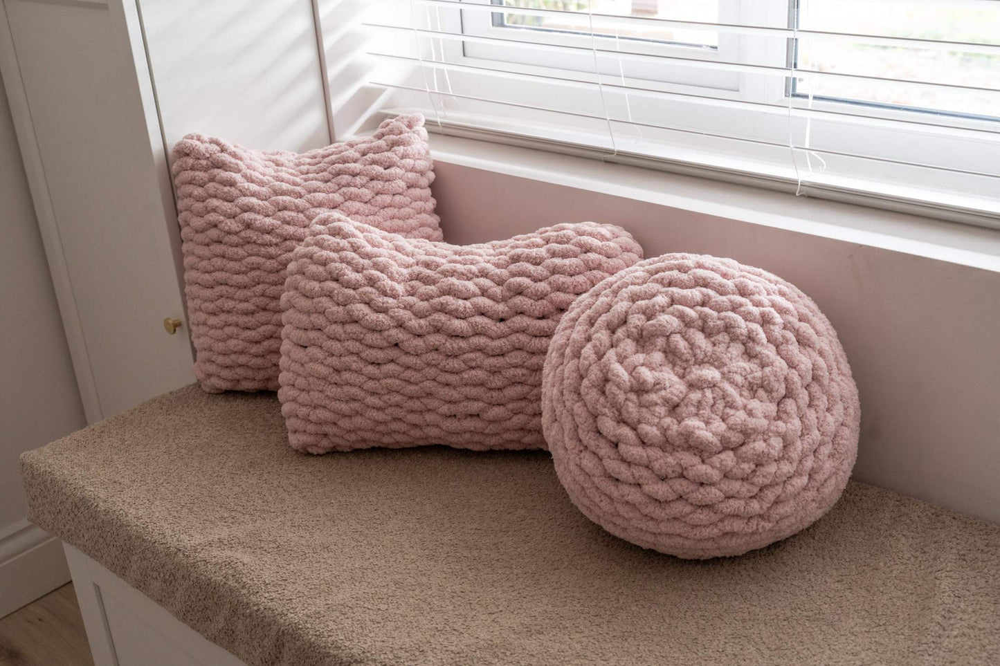 trio of pink hand knit cushions