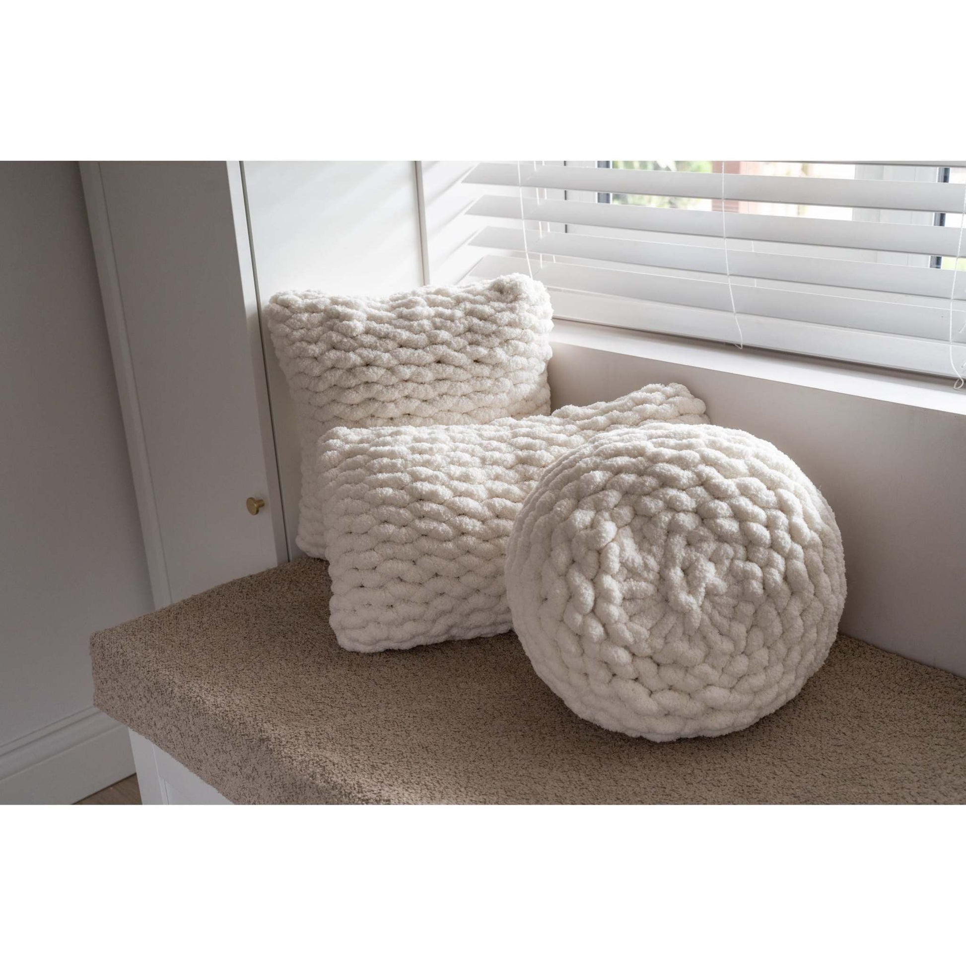 trio of cream hand knit cushions
