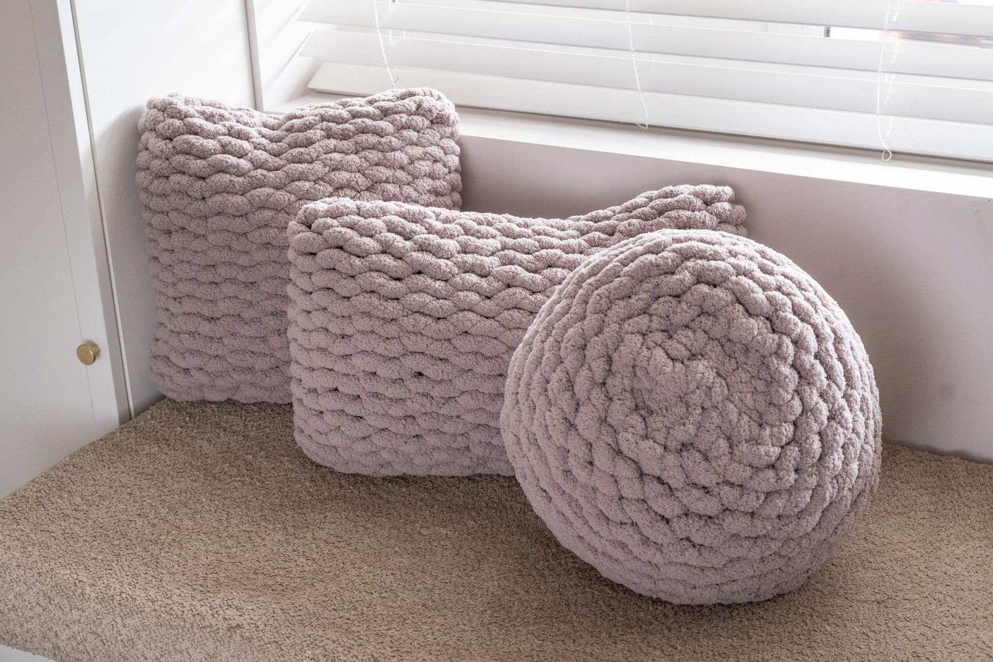 trio of grey hand knit cushions